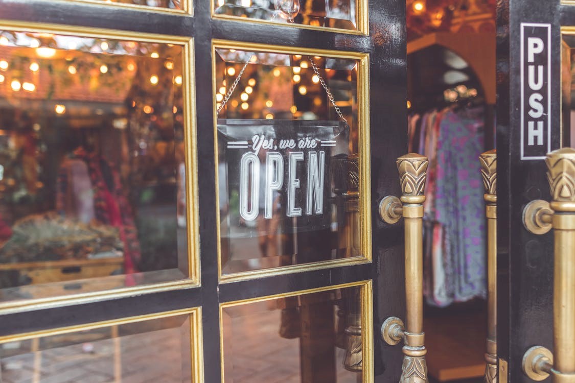 Small business shop window with a sign that says open