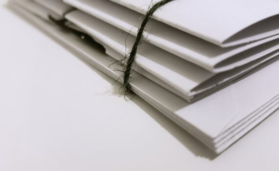 white paper folders with black tie