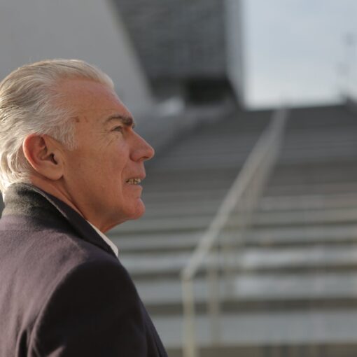 serious elderly gentleman on stone stairs in city