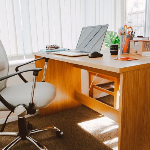 white rolling armchair beside table