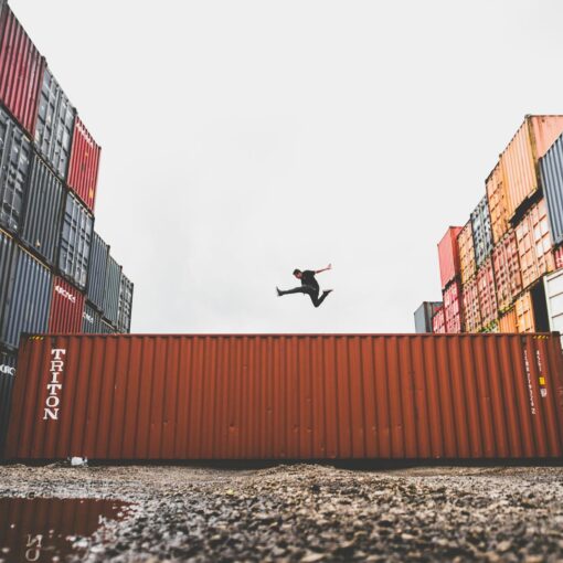man jumping on intermodal container